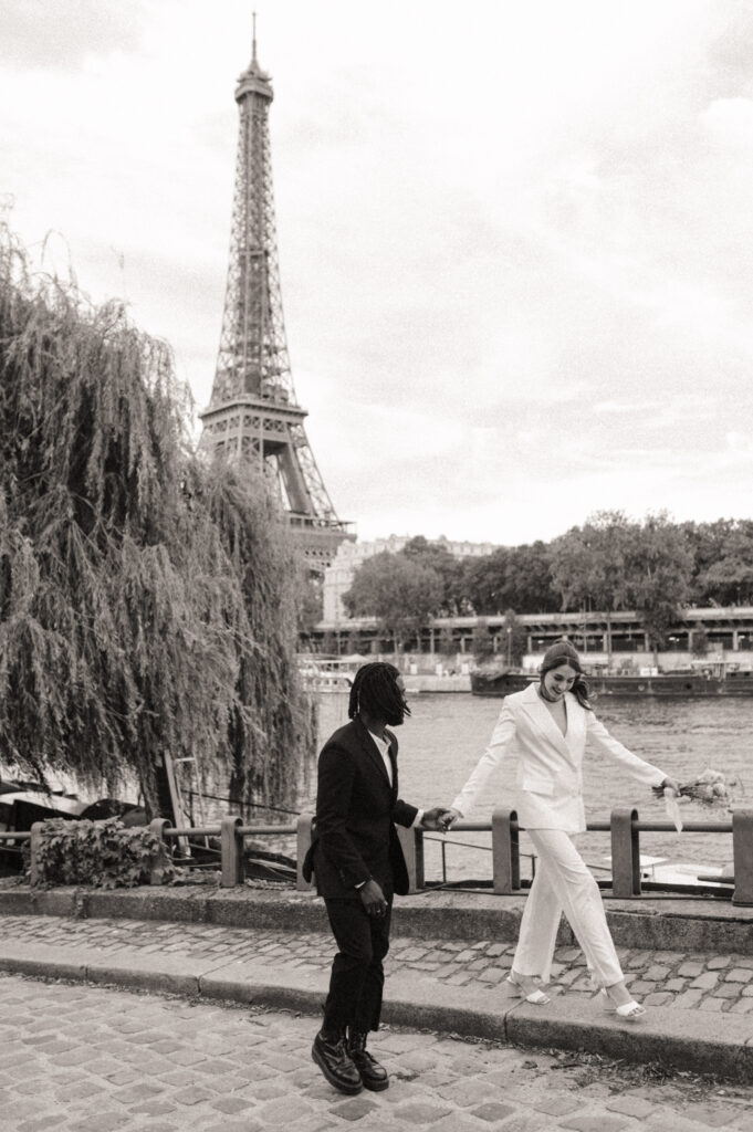 A couple takes walk around the streets near the Eiffel Tower in Paris after their Paris elopement 
