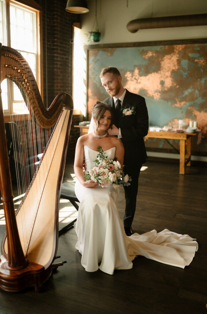 bride and groom with a harp at Tinker House Events