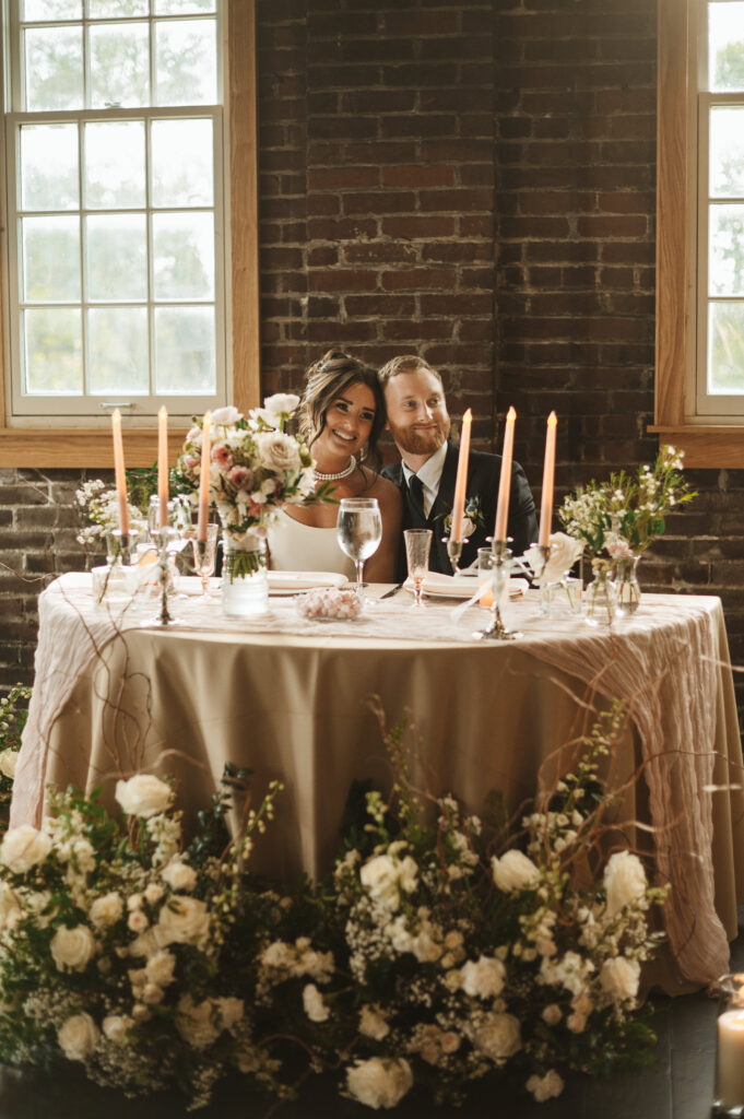 flower boys floral arrangement with table and couple at tinker house events in indianapolis