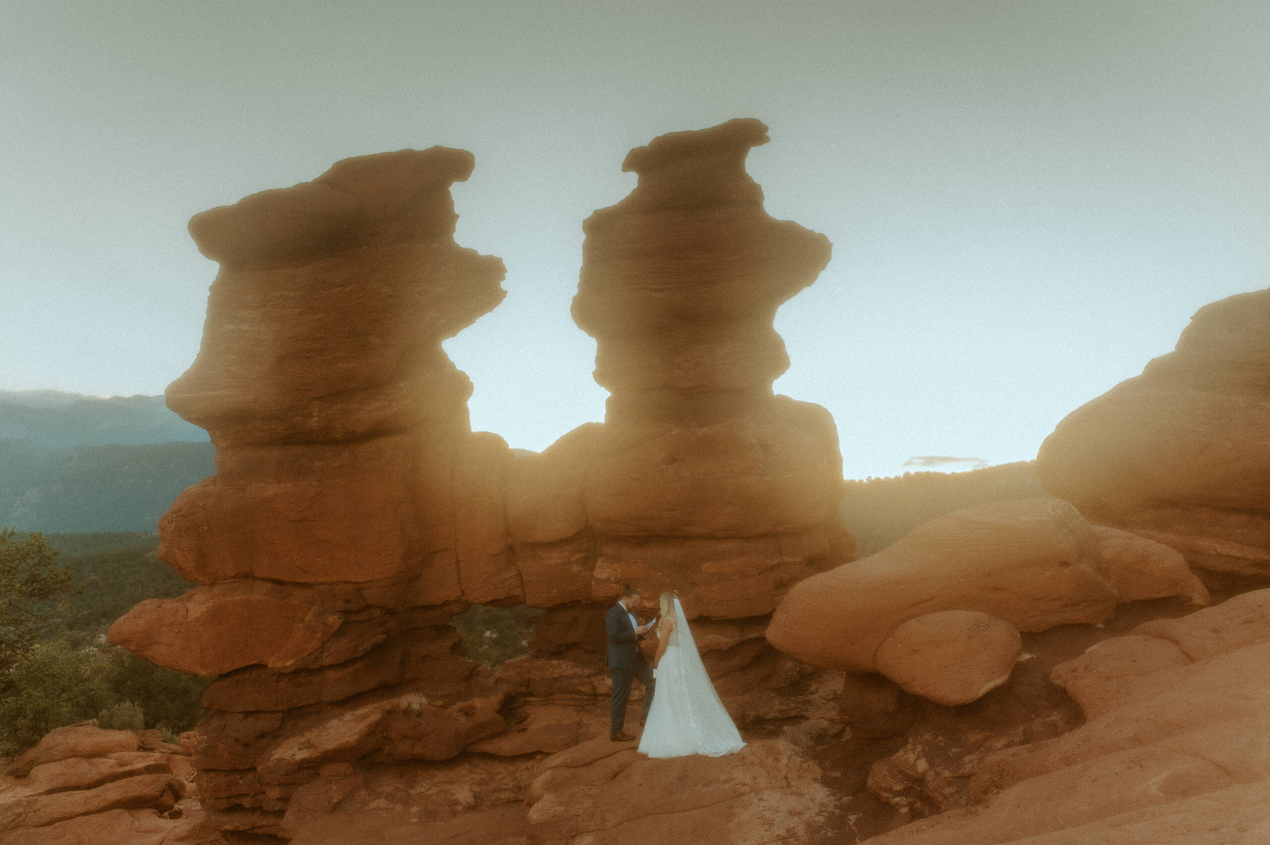 bride and groom eloping with the scenic siamese twin rock formation in garden of the gods in colorado springs