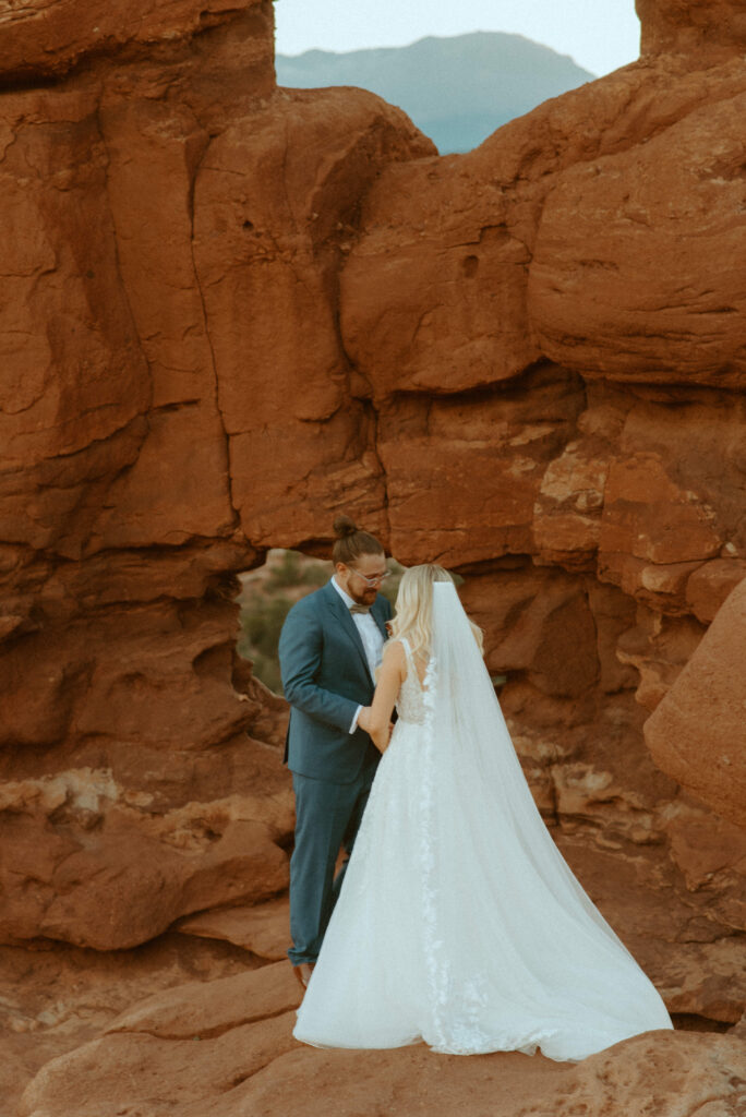 couple exchanging vows at siamese twins in garden of the gods in colorado springs